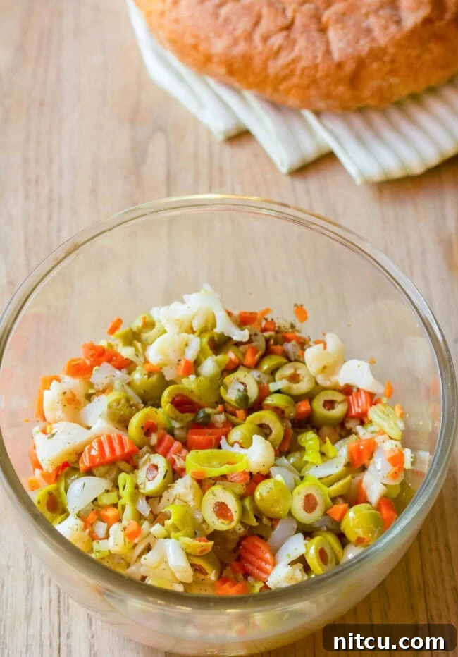 Fresh ingredients laid out for Muffuletta olive salad preparation.