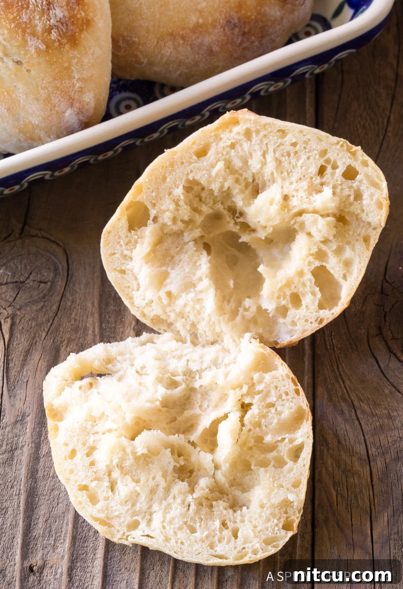 Croatian Lepinja Bread cut open on wooden board.