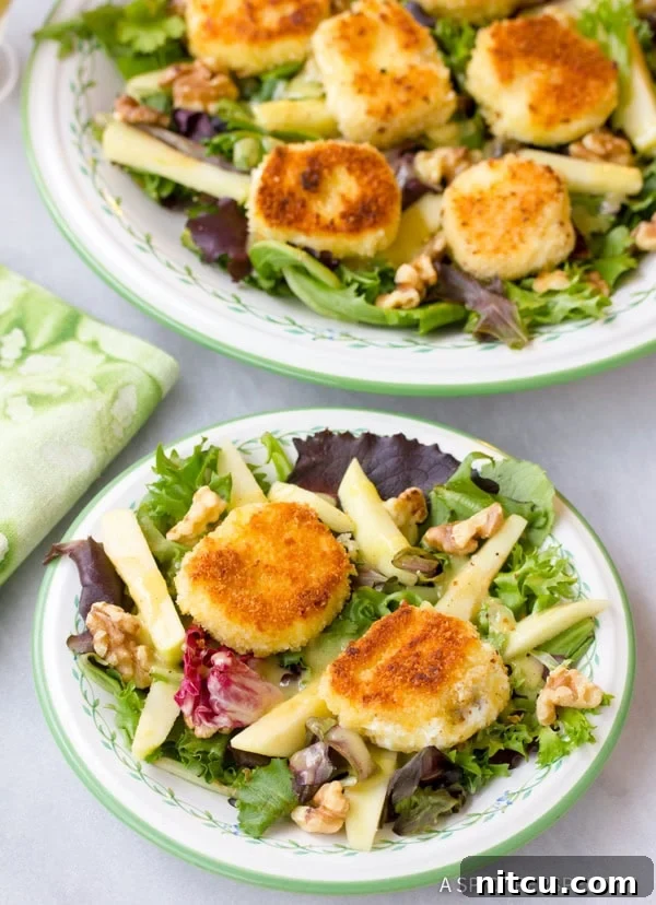 Fried goat cheese salad beautifully arranged on individual plates, ready to be served.