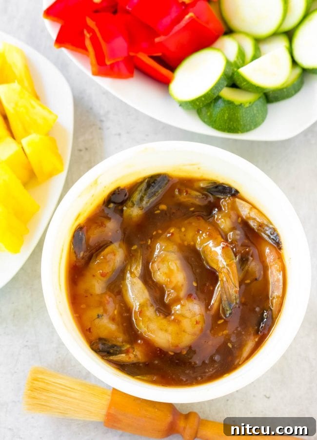 Shrimp soaking in a bowl of rich teriyaki marinade, absorbing all the flavors.