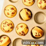 Corn Muffins Recipe - warm cornbread muffins in pan with bacon and maple syrup