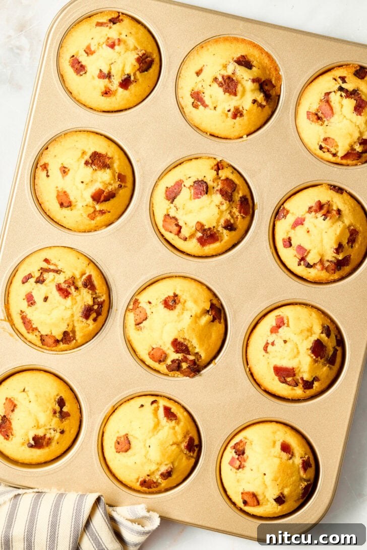 Warm corn muffins with crispy bacon in a baking pan