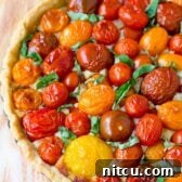 Perfect Fresh Tomato Tart Recipe: a whole tart with golden crust and red tomatoes.