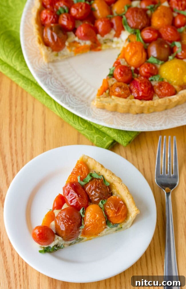 A slice being cut from the golden-brown tomato tart, revealing the creamy layers inside.