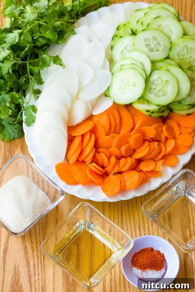 A colorful platter showcasing all the fresh Banh Mi sandwich toppings
