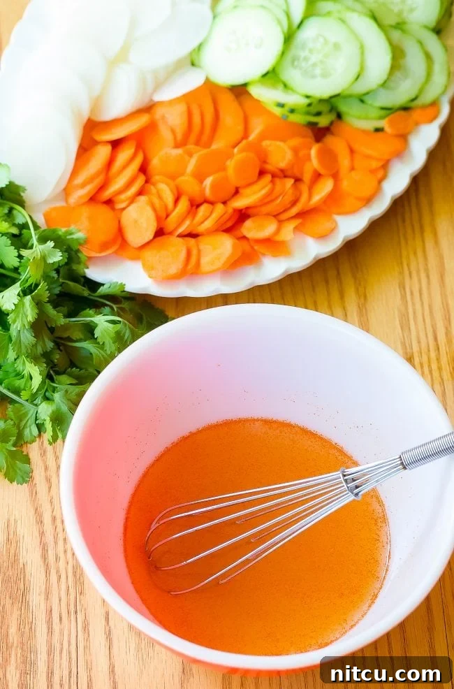 Banh Mi ingredients laid out with chicken marinating in a bowl