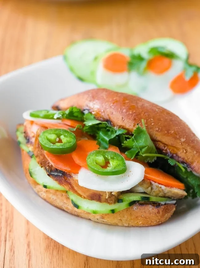 Close-up of a Banh Mi sandwich on a plate with fresh vegetables