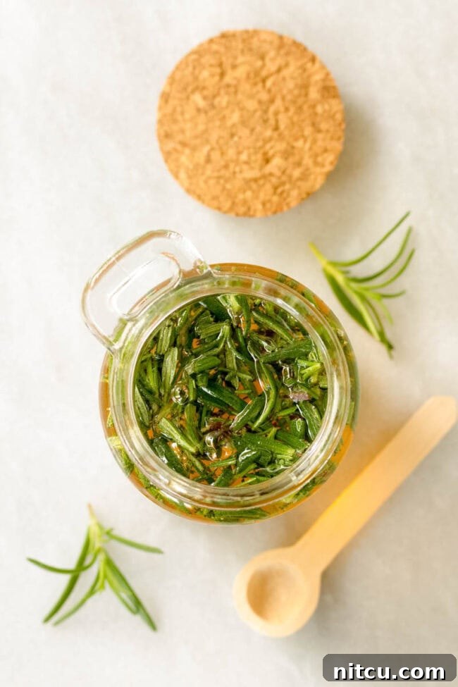 Infused Honey Recipe - Overhead shot of herbs soaking in the honey in a small jar. 