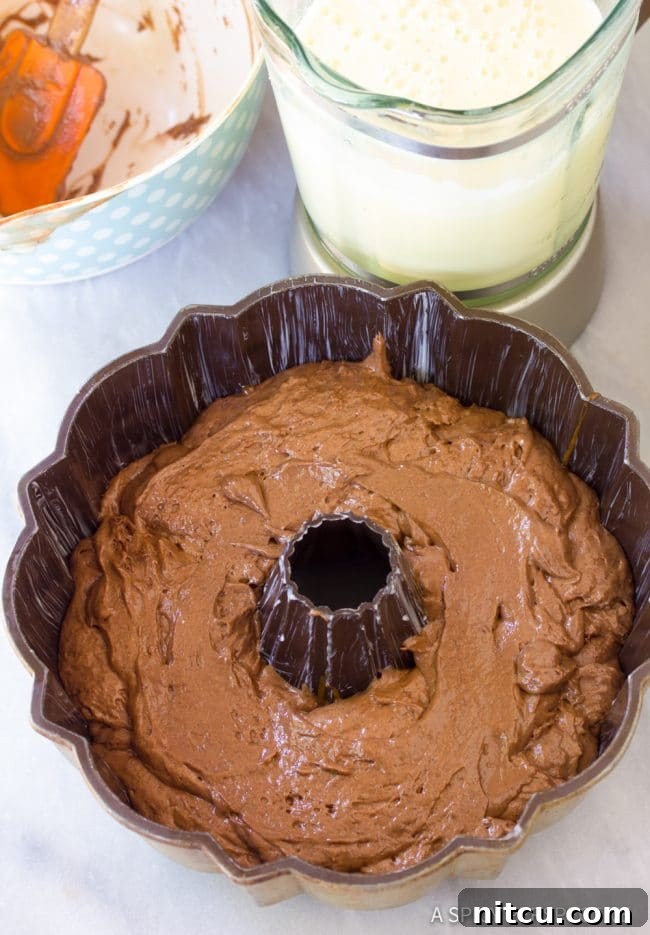 Assembling layers for Chocoflan: cake batter and flan mixture.