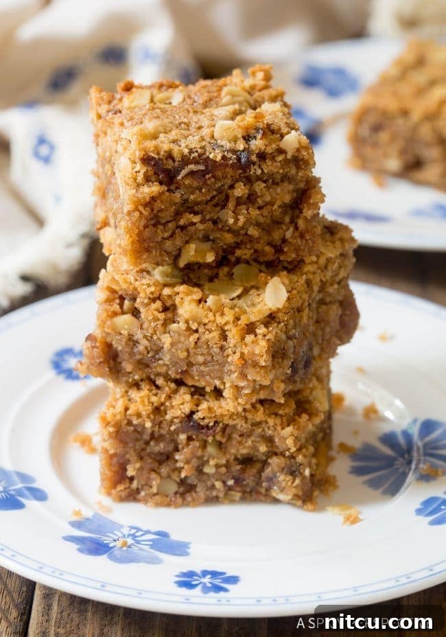Stack of egg-free oatmeal bars on a clean white plate, ready to be served.