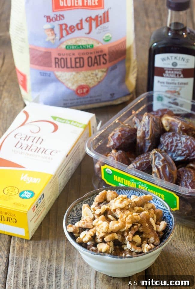 Ingredients for oat breakfast bars laid out on a table, including oats, dates, nuts, and butter.