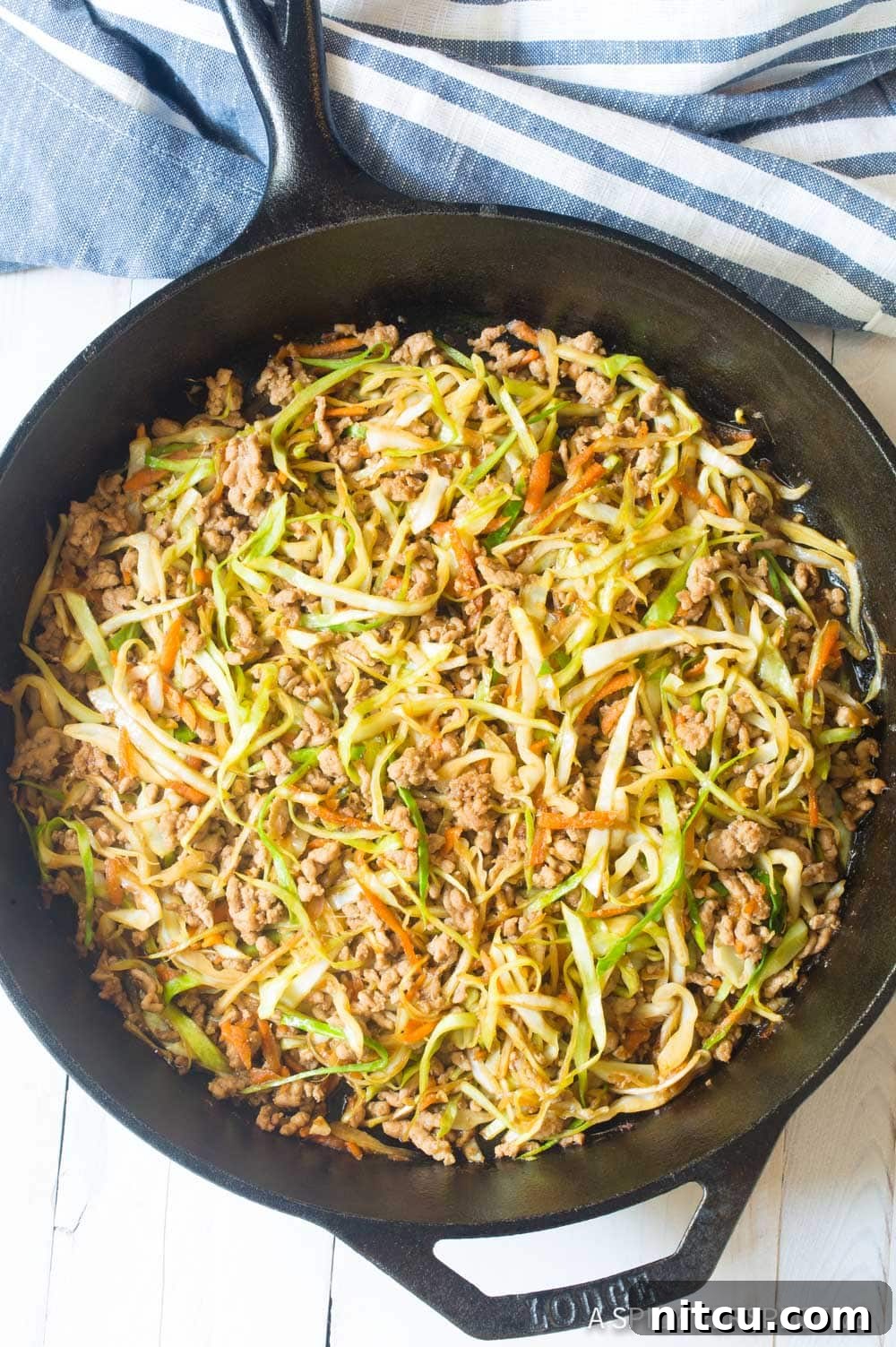 Skillet filled with egg roll pork filling. 