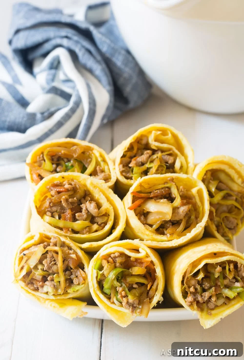 Keto Eggrolls - cut in half stacked on plate