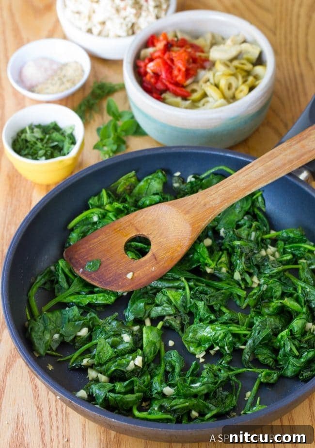 Sauteed spinach and garlic sizzling in a frying pan, releasing their aromatic flavors.