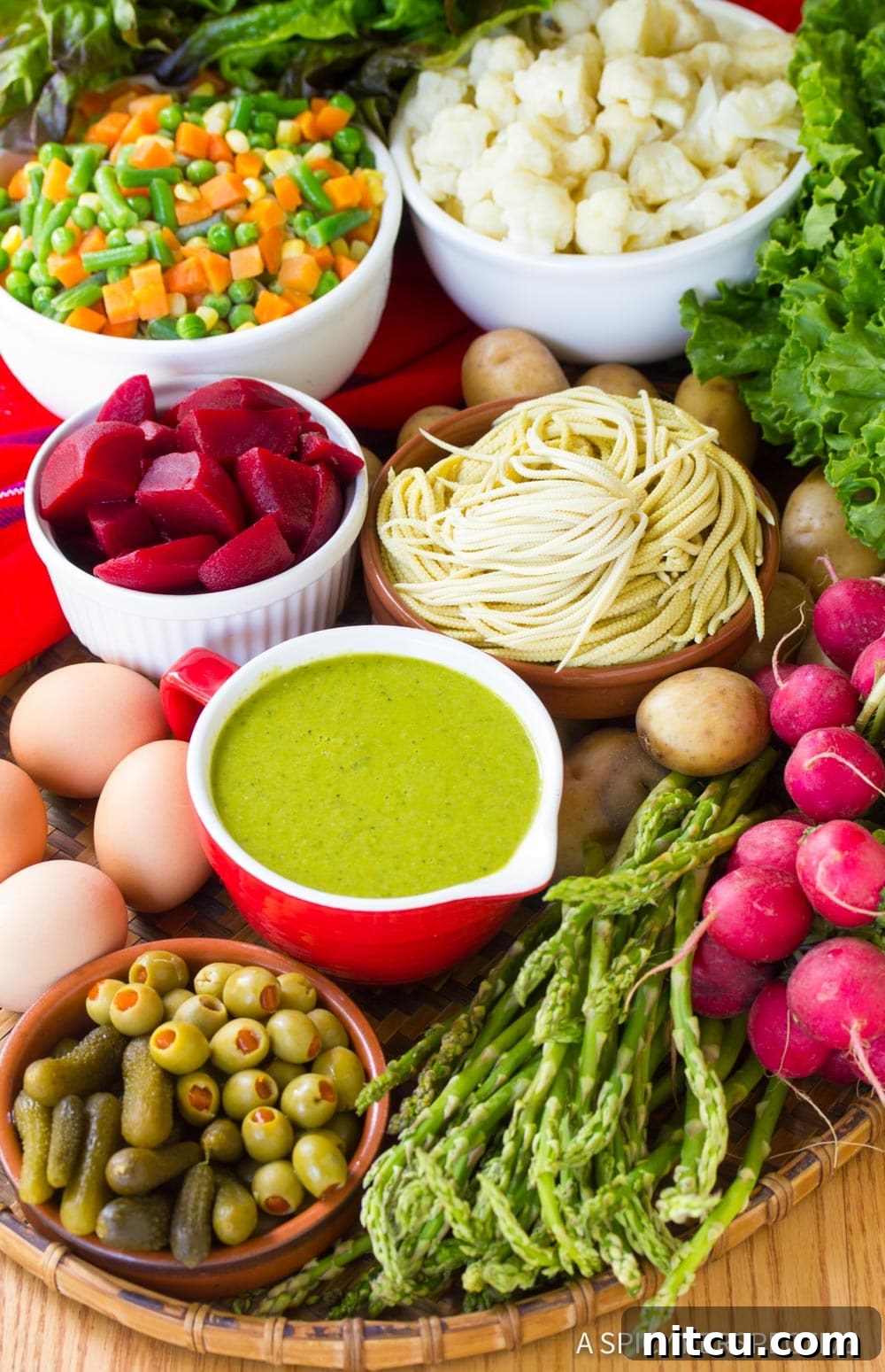 A collection of fresh, colorful ingredients laid out, ready for preparing Guatemalan Fiambre salad.