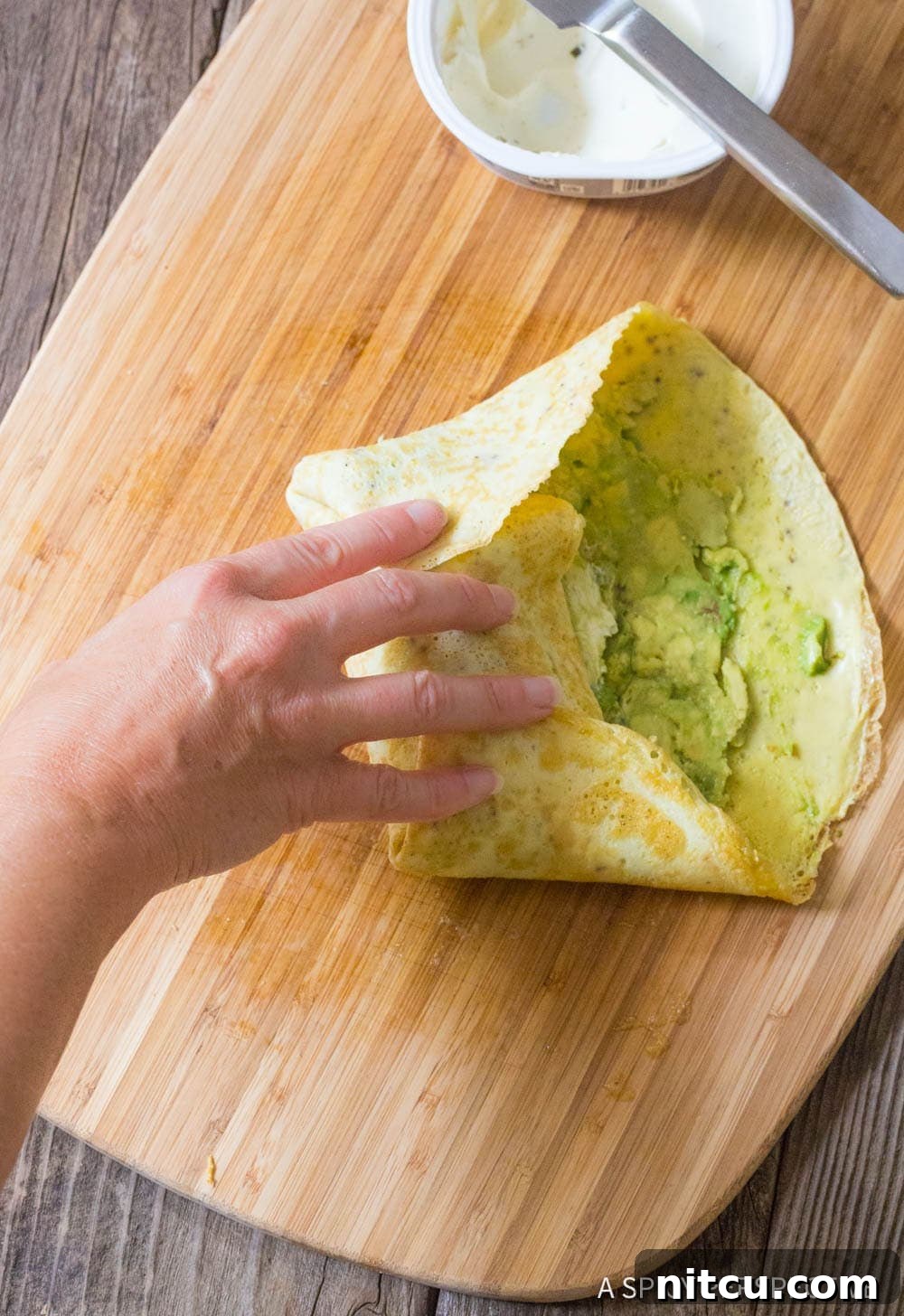 Hand wrapping a breakfast wrap up. 
