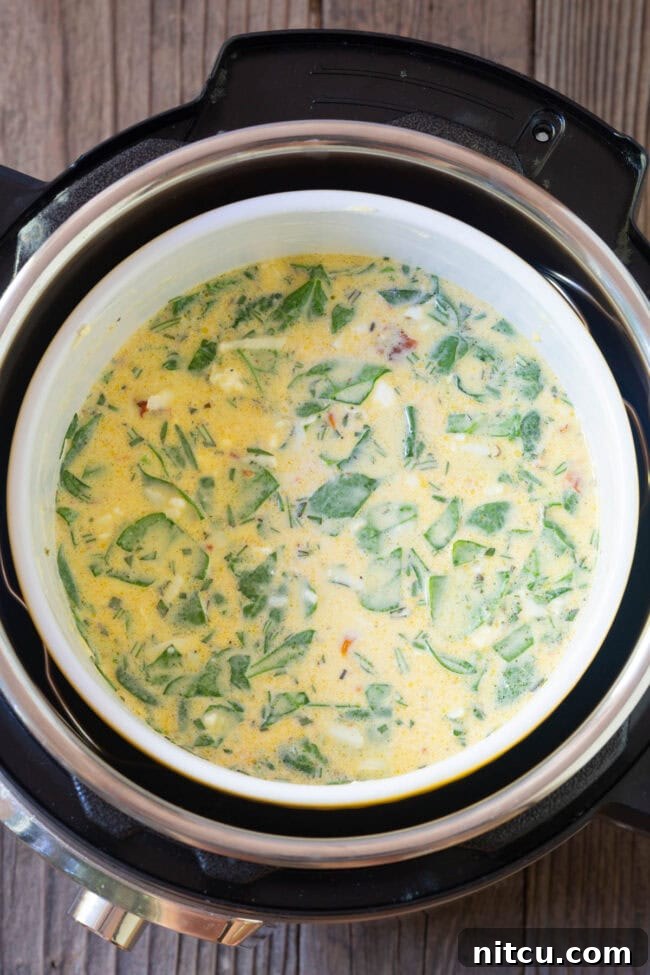 Souffle dish with quiche mixture being carefully placed into the Instant Pot before cooking.