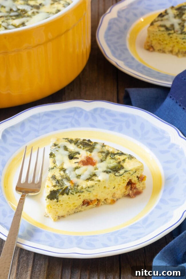 Close-up of a slice of fluffy, perfectly cooked quiche on a plate, highlighting its smooth texture and rich fillings.