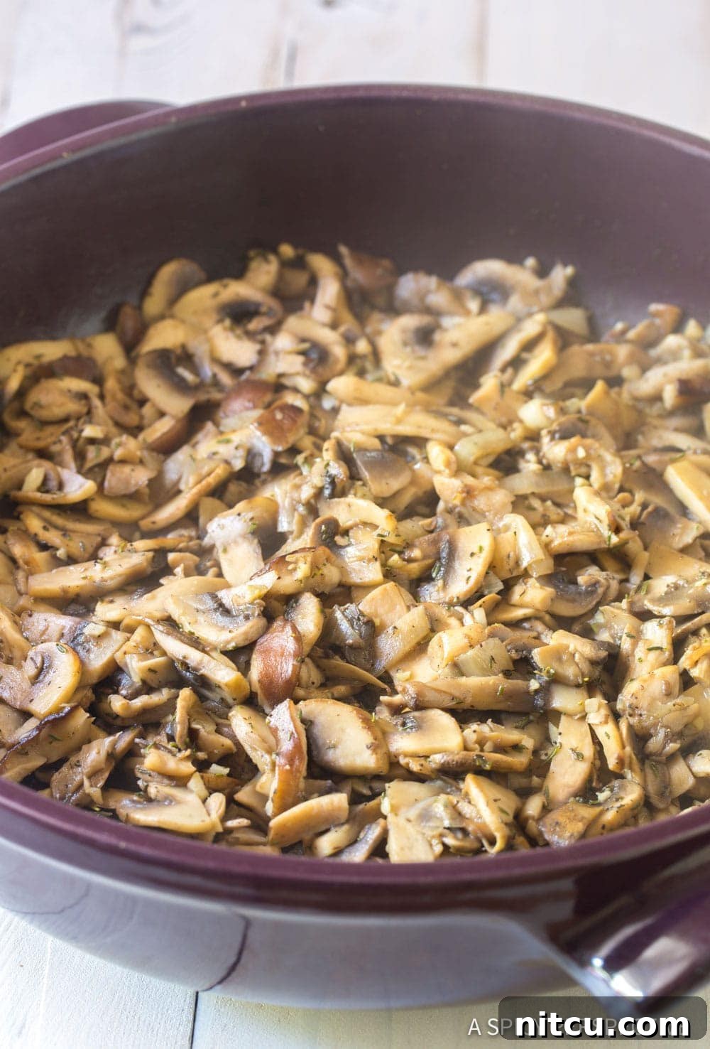 A close-up view of a pan filled with beautifully sautéed veggies and aromatics, forming the flavorful base for the pilaf.