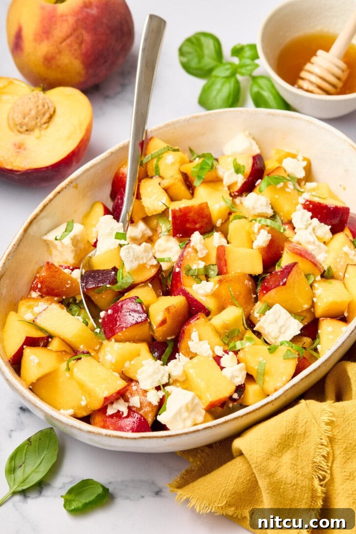 Fresh Peach Salad with Basil and Goat Cheese beautifully arranged on plates, ready to be served for a summer meal.