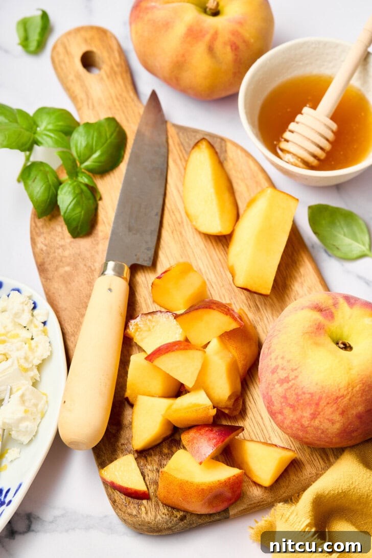 Preparing ingredients for a peach salad, showing fresh peaches being sliced and basil leaves ready to be chopped.