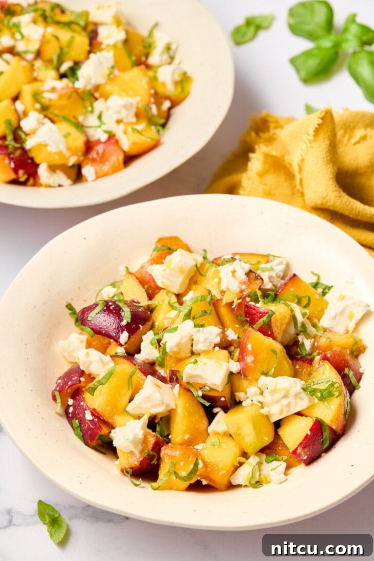 Easy summer salad with peaches and basil beautifully presented in individual bowls, perfect for a refreshing meal.