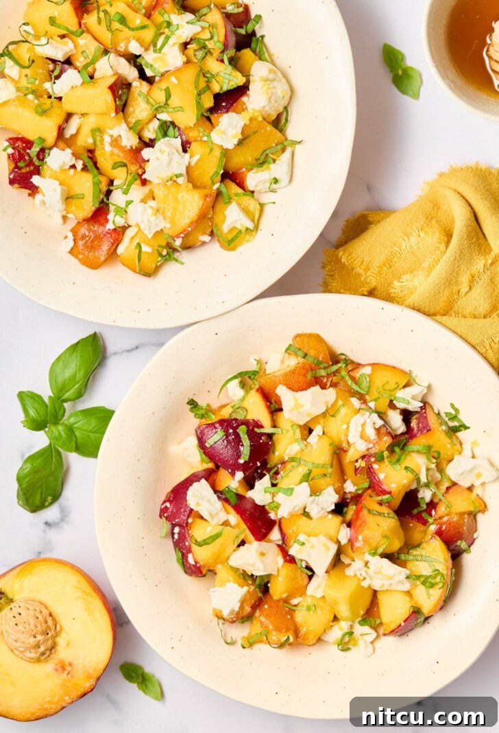 Peach salad ingredients beautifully mixed, creating a vibrant and fresh summer salad.