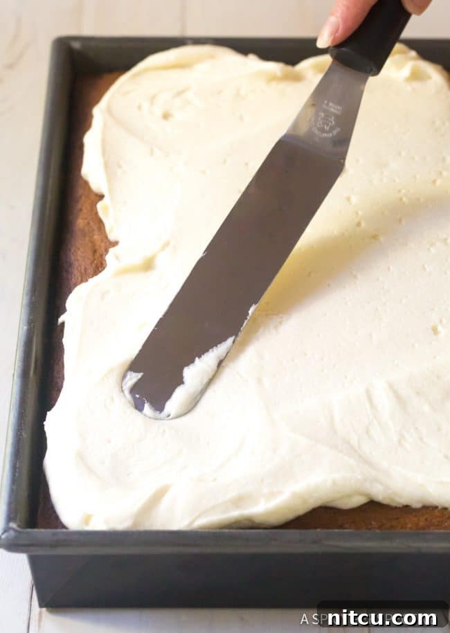 The smooth, combined batter for Moist Pumpkin Texas Sheet Cake in a stand mixer bowl.