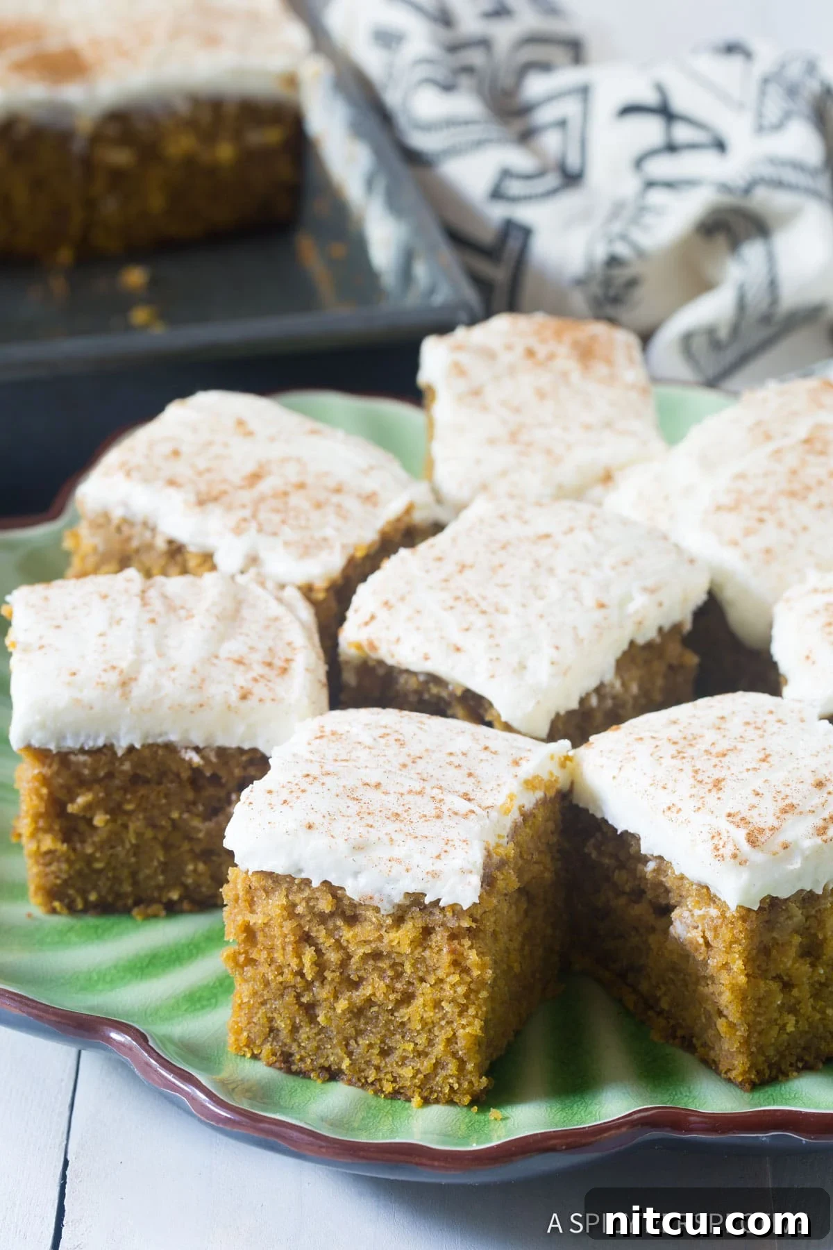 Easy Pumpkin Cake with Buttermilk Frosting, with several cut pieces artfully arranged on a serving platter.