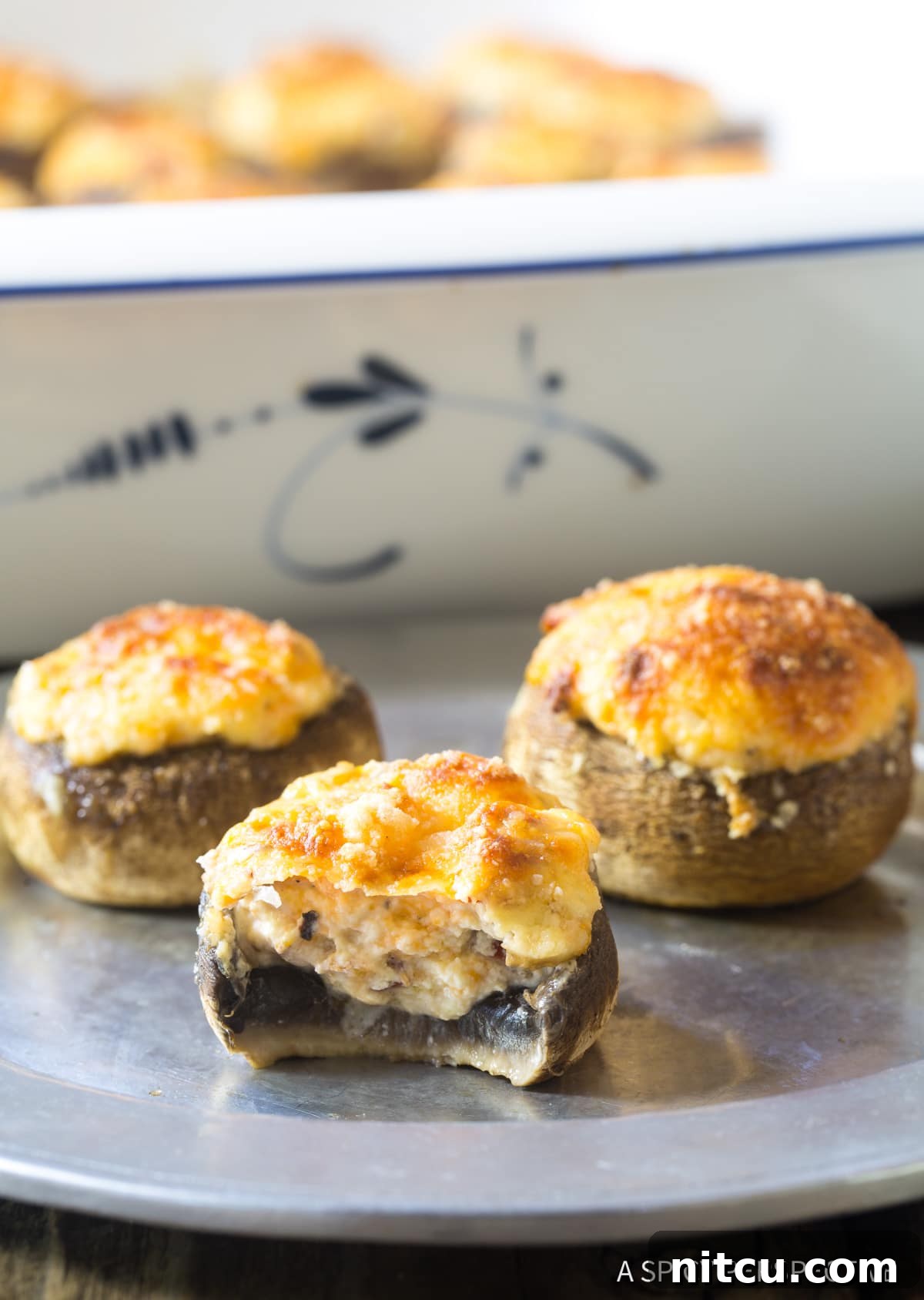 A close-up of cheese-stuffed mushrooms, perfect as appetizers or snacks, showing their inviting golden-brown tops.