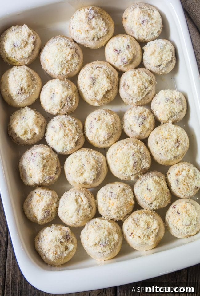 Cheese Stuffed Mushrooms recipe in a baking dish, neatly arranged and ready for the oven before baking to golden perfection.