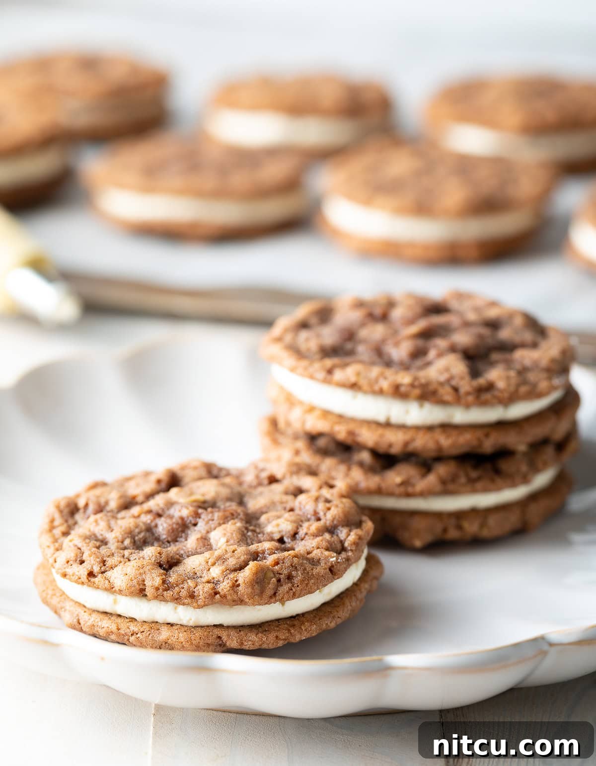 Perfectly baked Oatmeal Cream Pies arranged on a serving plate.