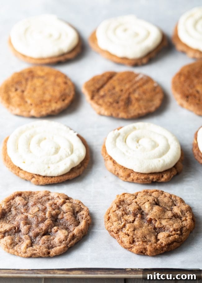 Oatmeal cookies topped with generous dollops of fluffy cream pie filling, ready for their top layer.