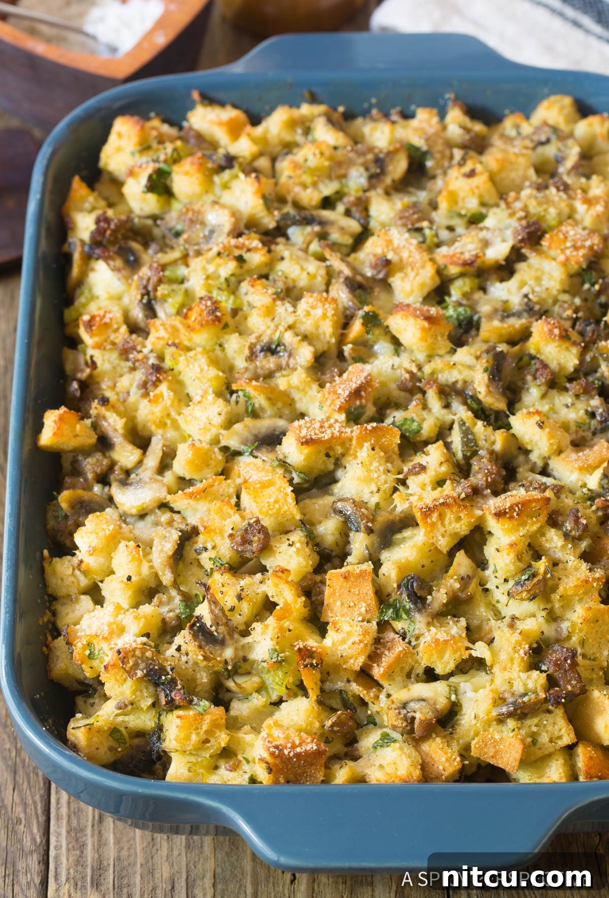 Sausage Mushroom Thanksgiving Stuffing Recipe in casserole dish with golden brown top.