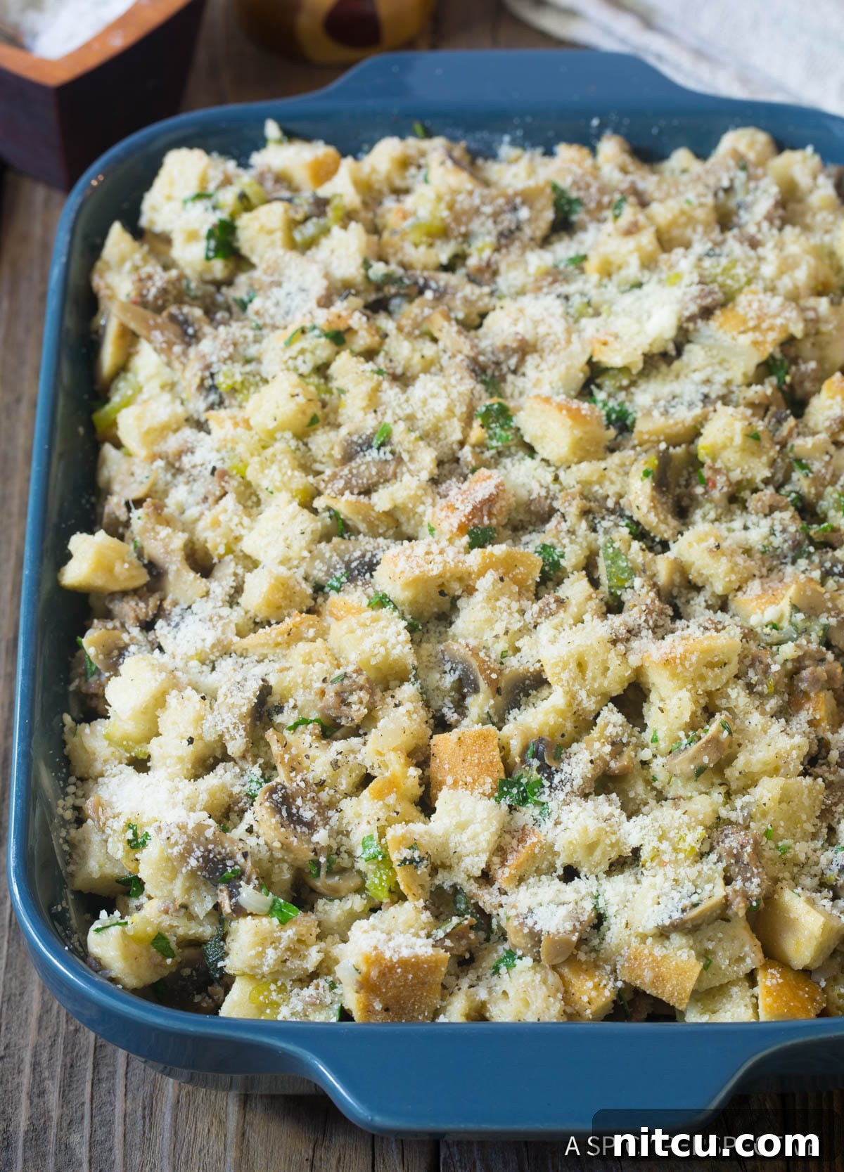 Unbaked thanksgiving stuffing with mushrooms and sausage - cheese on top