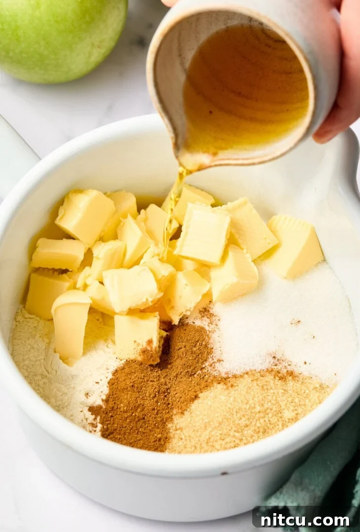 Mixed apple filling ingredients being prepared to pour over diced apples for a rich flavor.