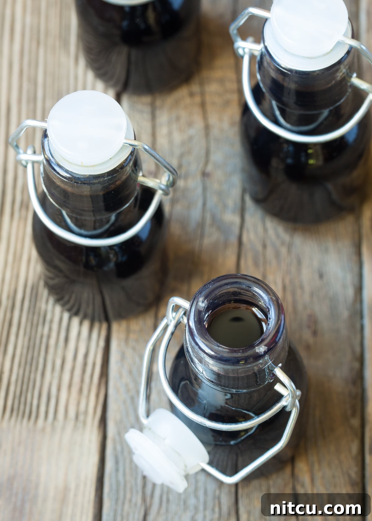 Trendy Homemade Bourbon Vanilla Extract in small bottles.