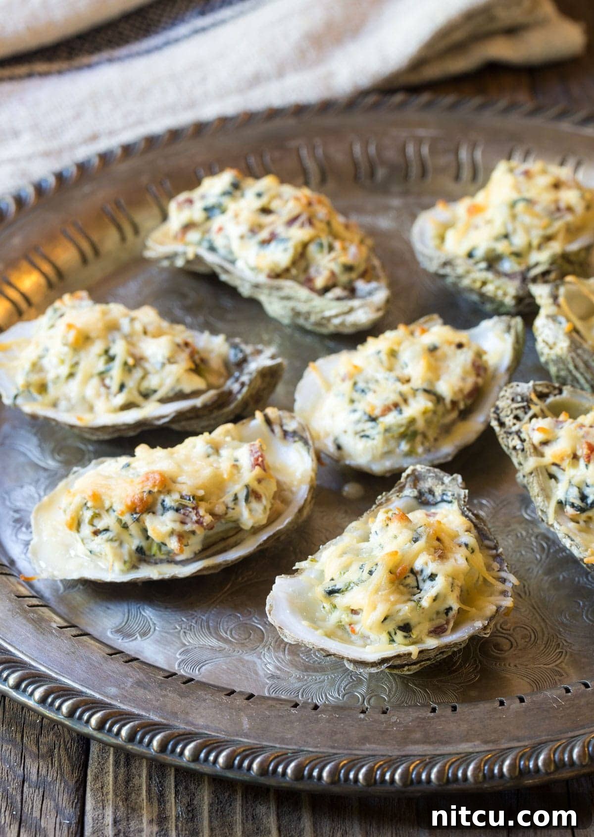 Best baked oysters recipe on a tray, topped with perfectly melted golden cheese