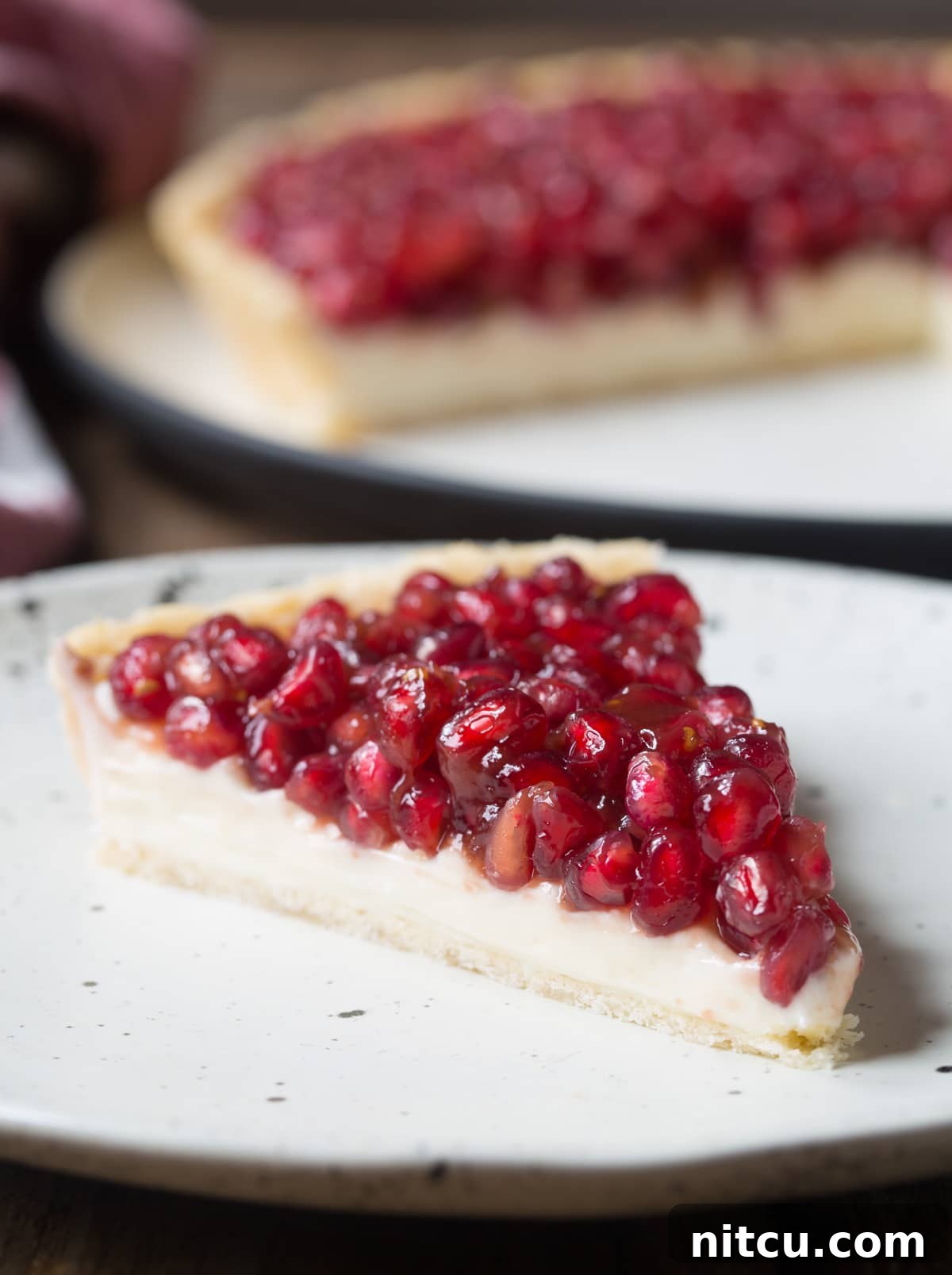 Simple Pomegranate Cream Cheese Tart Recipe - cut on plate