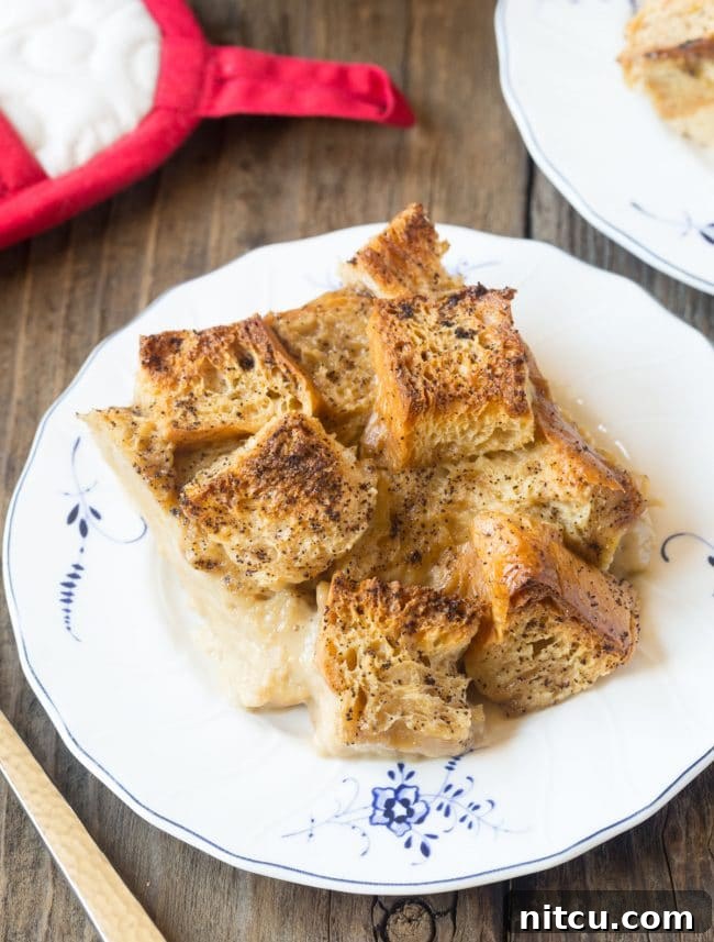 Piece of bread pudding on a white plate.