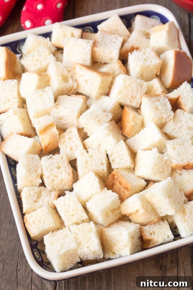 Cubes of brioche bread in a baking pan.