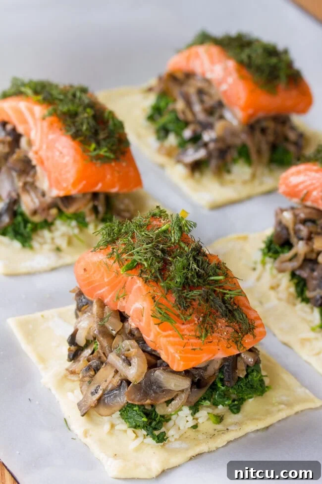 Fresh dill being sprinkled generously over a salmon fillet in a partially assembled Salmon Coulibiac, adding aromatic flavor.