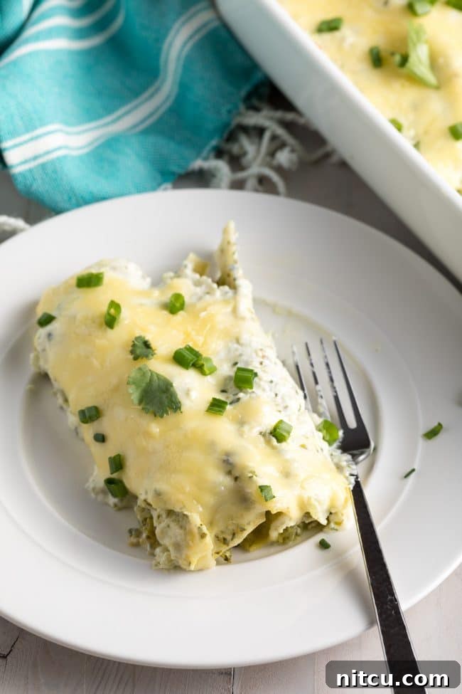 The Perfect Enchiladas Suizas Recipe (Creamy Chicken Enchiladas) on a cutting board, garnished.