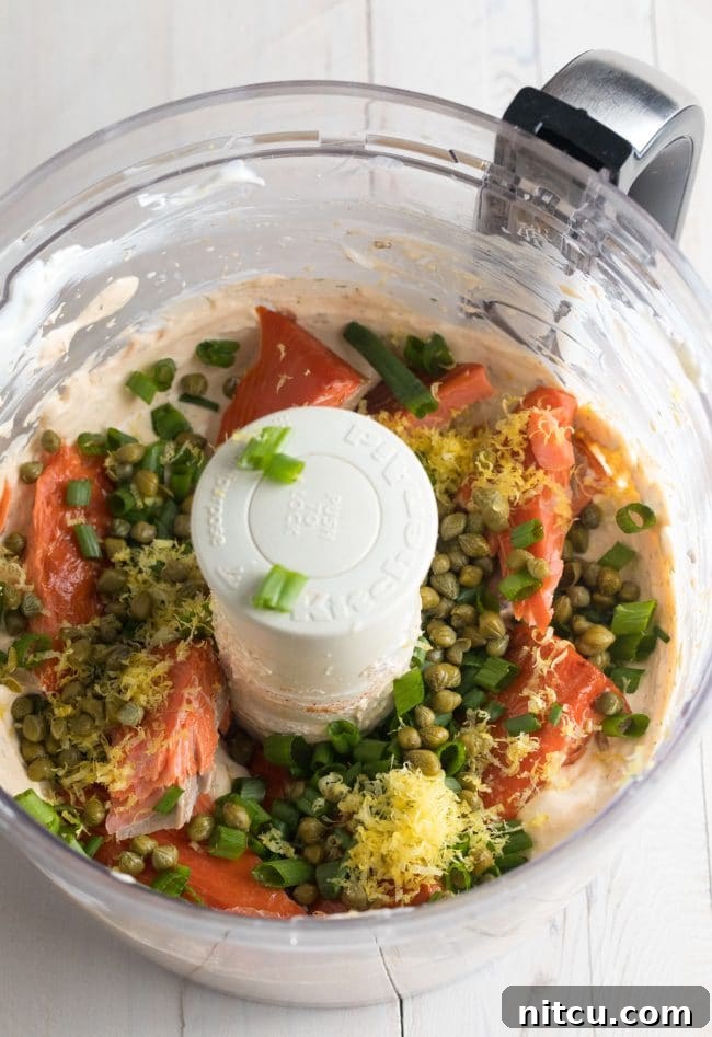 The remaining fresh and flavorful ingredients being added to the food processor for the final blend, ensuring perfect incorporation.