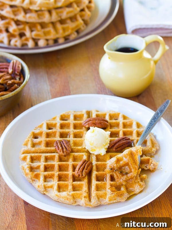 Healthy Spelt Waffles served with diverse toppings including nuts, berries, and syrup.
