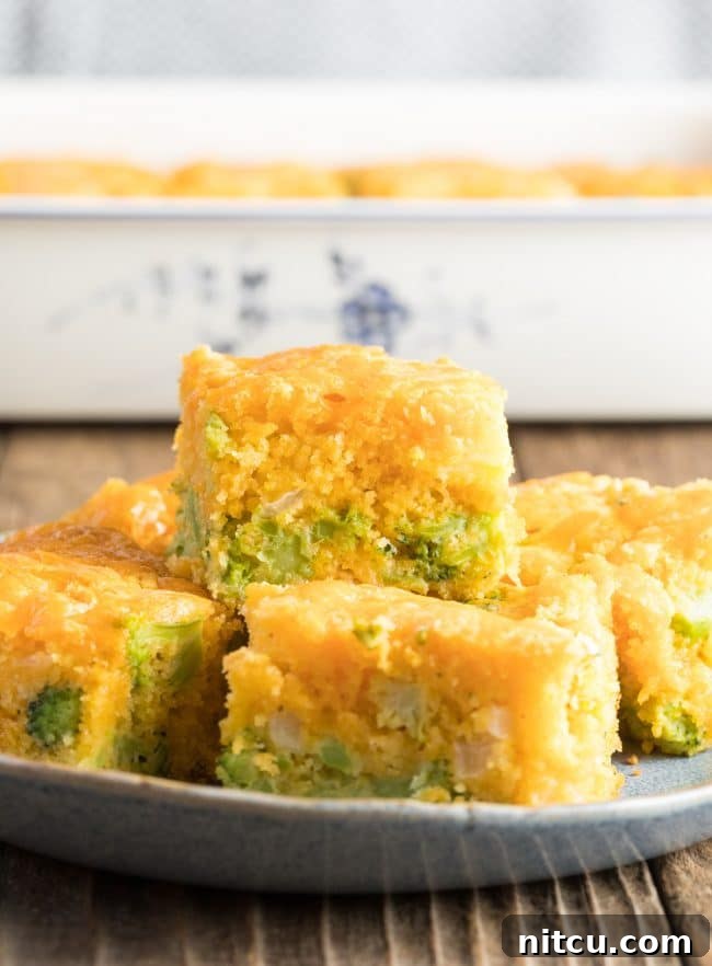 Stacked pieces of fluffy broccoli cornbread, golden-brown and inviting
