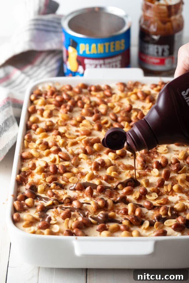 Final layer with more peanuts and chocolate Magic Shell drizzled on top, hardening instantly.