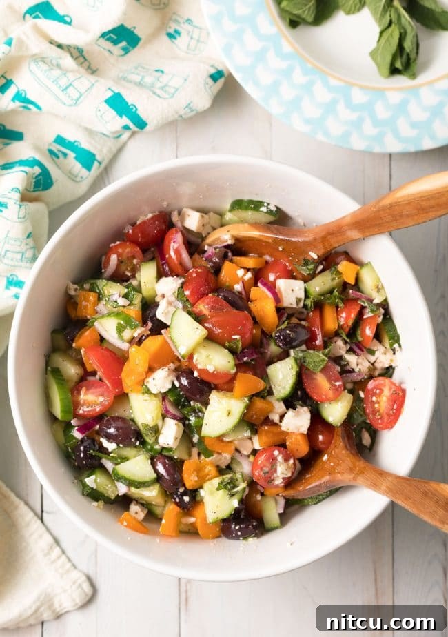 Authentic Horiatiki (Greek Village Salad) Recipe with a block of feta cheese on top, ready to be served. #greek #salad #glutenfree #lowcarb #keto #vegetarian