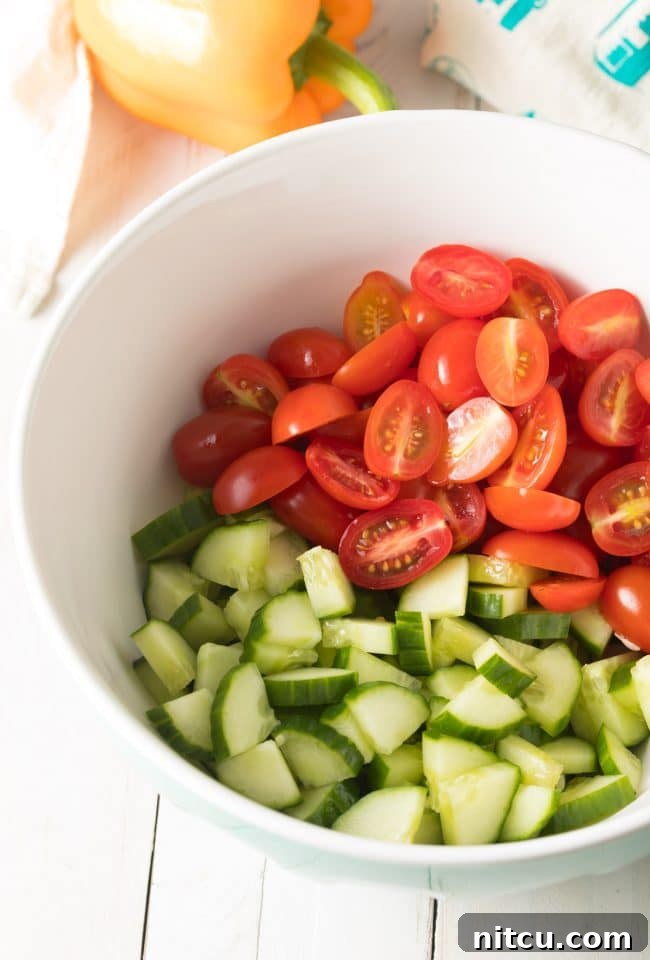 Greek Horiatiki (Village Salad) Recipe showing ingredients being chopped. #greek #salad #glutenfree #lowcarb #keto #vegetarian