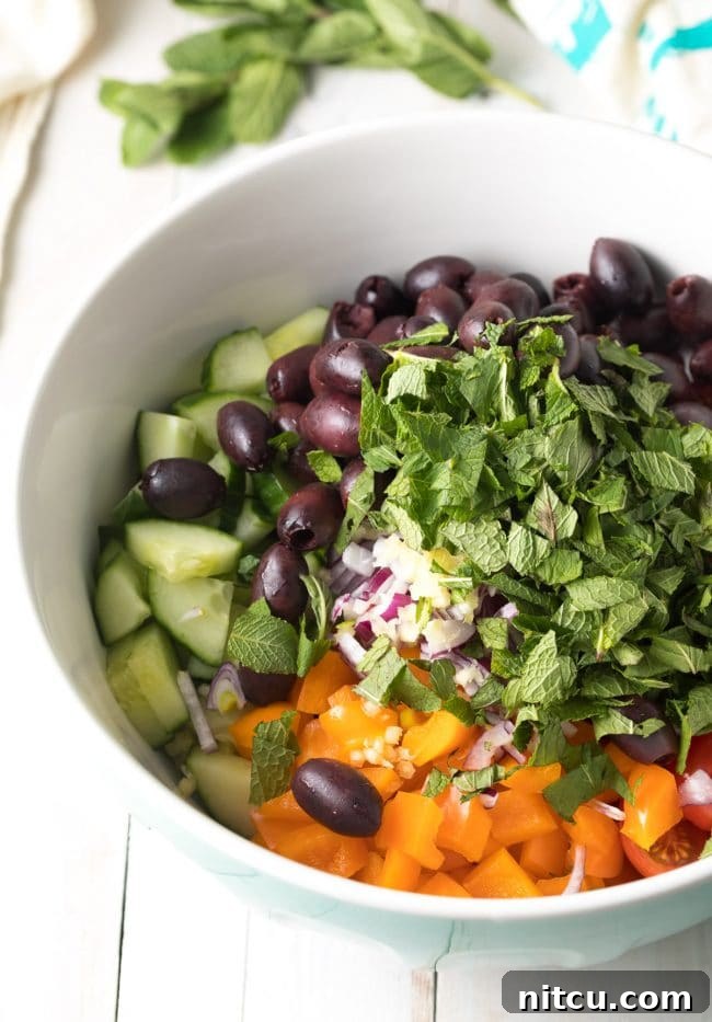 Easy Greek Horiatiki (Village Salad) Recipe showing the chopped vegetables in a bowl. #greek #salad #glutenfree #lowcarb #keto #vegetarian